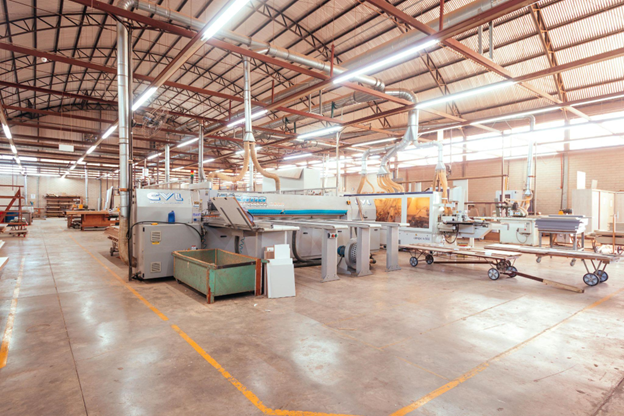 Modern factory floor with automated equipment and energy-efficient systems, highlighting sustainability in industrial automation. 